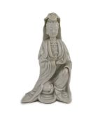 A Chinese blanc-de-chine seated figure of Guanyin, Dehua kilns, 18th century,19cm high, losses to