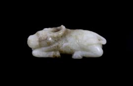 A Chinese Ming pale celadon and brown jade figure of a recumbent Buffalo, 16th/17th century,with