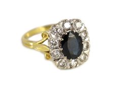A 1970's 18ct gold, sapphire and diamond set rounded rectangular cluster ring,with pierced scroll