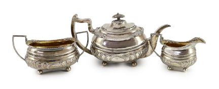 A George III Scottish silver demi-fluted three piece tea set by George Fenwick,of oval form, with