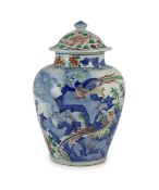 A Chinese transitional wucai jar and cover, c.1650,with typical unglazed base, painted with