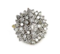 An impressive gold, platinum and diamond set circular cluster ring,the central round brilliant cut