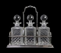 A modern silver three bottle rectangular decanter stand, by C.J. Vander Ltd,with decorated top