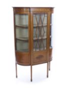An early 20th century inlaid mahogany display cabinet,with central astragal glazed door, bowed