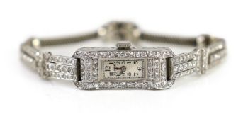 A lady's mid 20th century platinum and diamond set manual wind cocktail watch, retailed by Asprey,