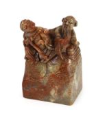 A Chinese soapstone seal, 18th century,surmounted by the figures a trader and a foreigner,