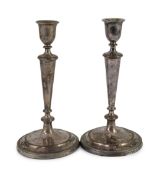 A pair of Sheffield plate candlesticks and nozzles,of circular form with reeded borders, one