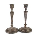 A pair of Sheffield plate candlesticks and nozzles,of circular form with reeded borders, one