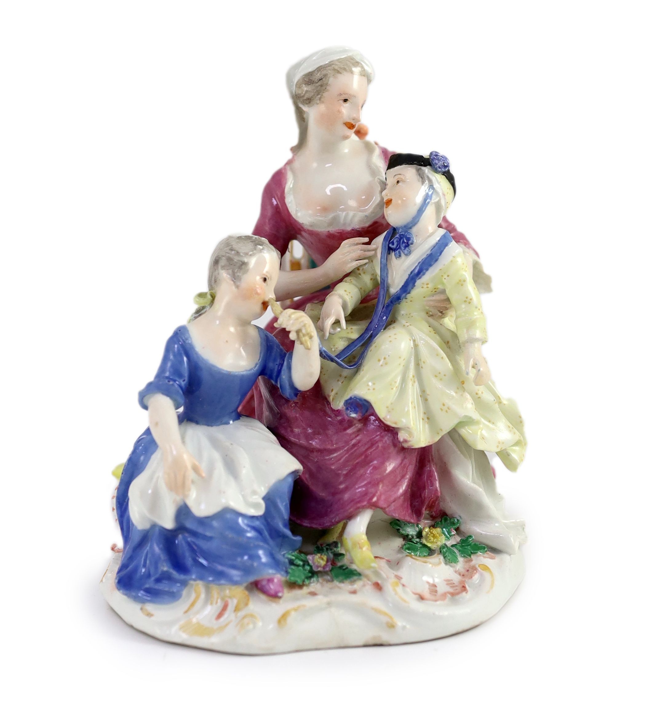 A Meissen group of a seated lady and two children, mid 18th centurymodelled by Kändler, crossed
