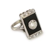 A platinum, single stone diamond and black onyx set rectangular tablet ring, with eight stone