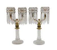 A pair of Regency ormolu and cut glass two branch candelabra,each surmounted by a pair of ormolu