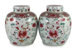 A good pair of Chinese famille rose ovoid jars and covers, 19th century,each painted with three