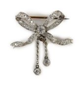 A Victorian gold, silver and diamond cluster set ribbon bow brooch, with two diamond set graduated