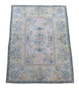 An Aubusson style ivory ground carpet,woven with ribbon tied floral sprays, and baskets of