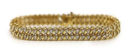 A modern 14k gold and twin row diamond set line bracelet,set with one hundred stones, 18cm, gross
