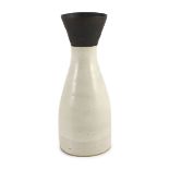 § § Dame Lucie Rie (1902-1995), a stoneware conical vase,covered in a cream glaze, the flared neck