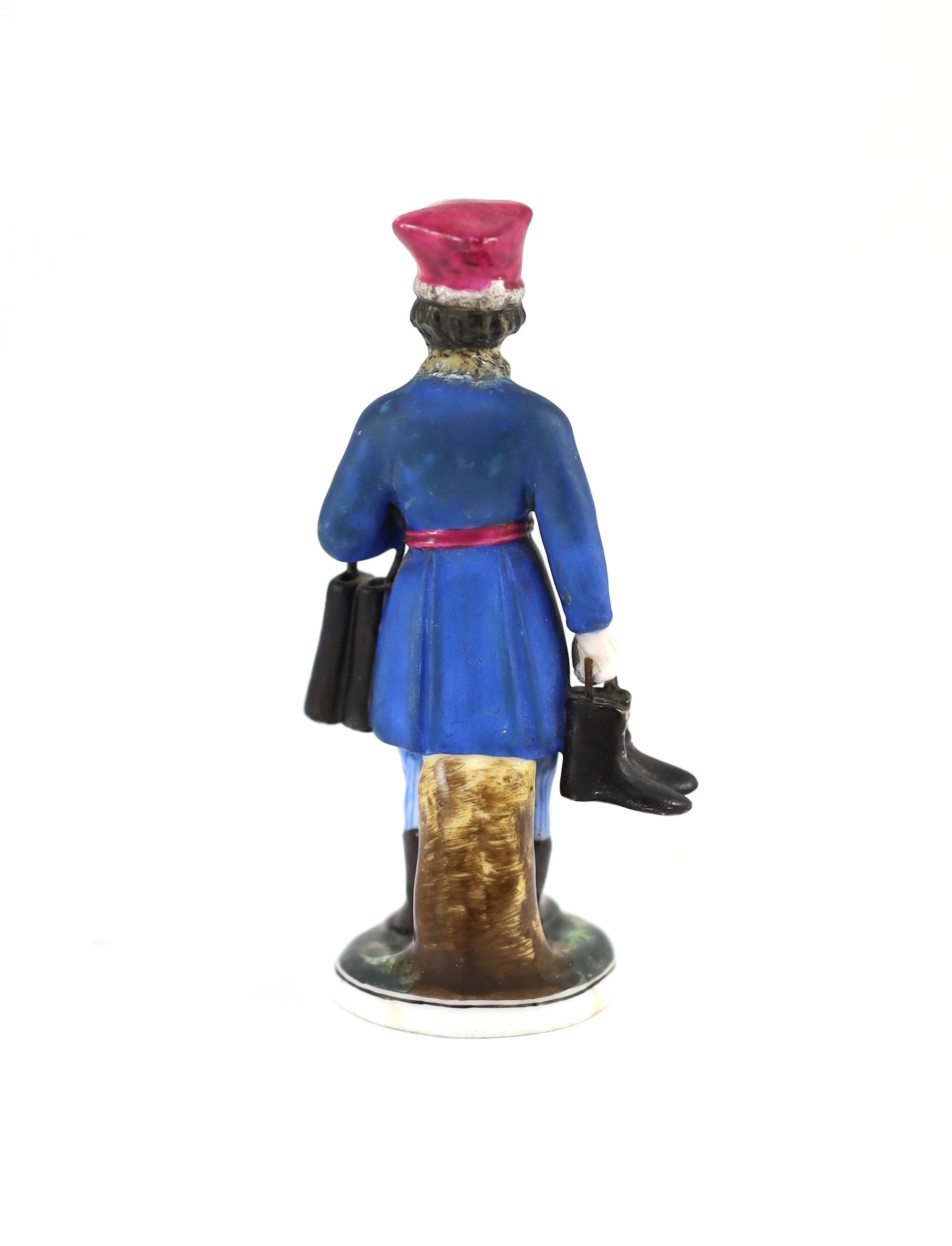 A Russian porcelain figure of a boot seller, Gardner Manufactory, Verbilki, c.1825,on a circular - Image 2 of 3
