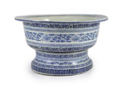 A unusual Chinese blue and white pedestal bowl or basin, 19th century,painted with scrolling foliage