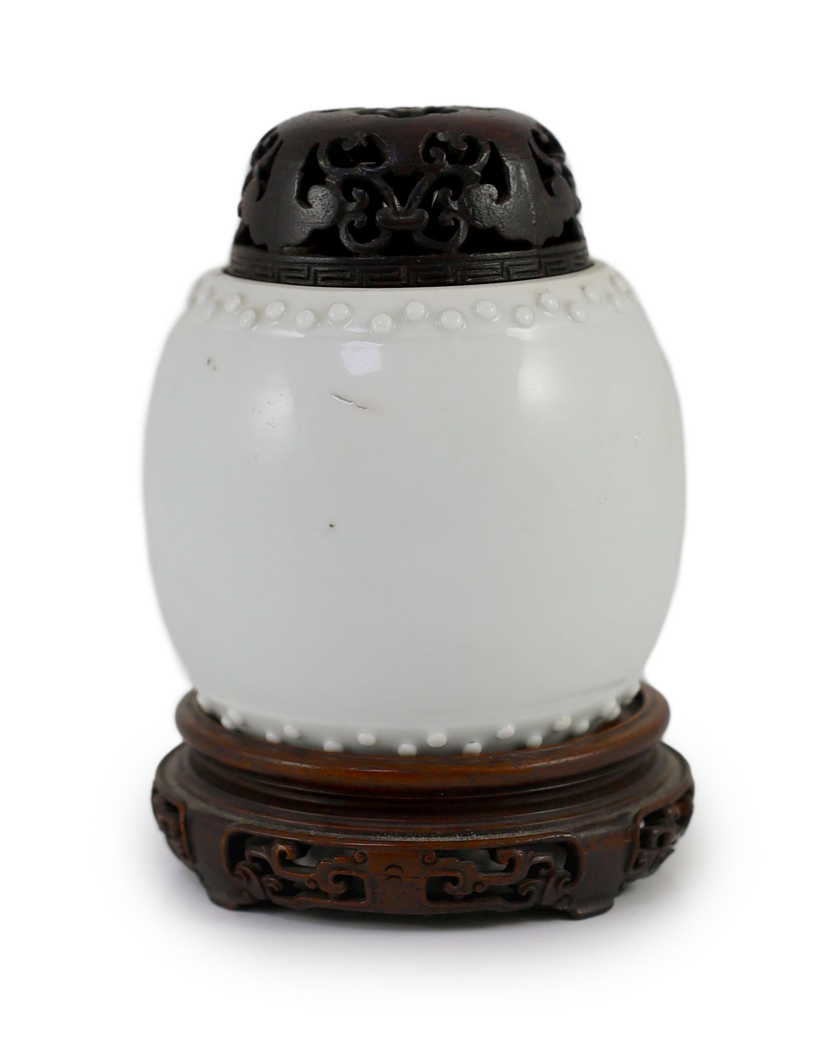 A Chinese blanc-de-chine jar, Dehua kilns, Kangxi period,of barrel seat form,8cm high excluding wood