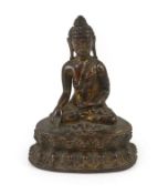 A small Tibetan gilt copper alloy seated figure of Buddha Shakyamuni, probably 15th/16th century,