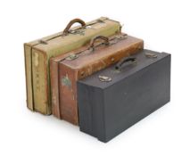 A leather suitcase,the leather suitcase fitted with silver mounted cut glass bottles and two
