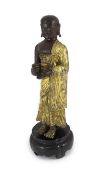 A Tibetan repousse work gilt and lacquered copper figure of a luohan, 18th century,standing and