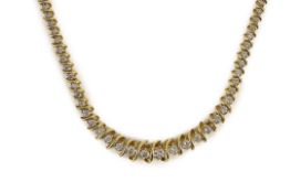 A modern 14k gold and graduated diamond set shaped line necklace,the largest stone weighing