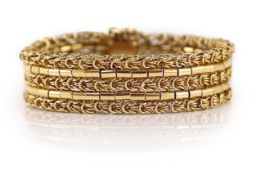 A 20th century 18k gold interwoven three row bracelet,with safety chain. interior length approx.