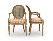 A set of four late 18th century French carved beech fauteuils,with caned backs and seats, on