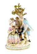 A Meissen group of flower pickers, 19th century,modelled as a seated lady playing a mandolin with