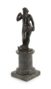 A small Roman bronze figure of Neptune standing with his foot upon a dolphin,on green marble socle,