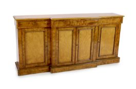 A Victorian walnut breakfront dwarf bookcase,with moulded top and three frieze drawers over cupboard