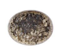 A Chinese pale grey and black jade oval plaque, Yuan dynasty or later,carved and reticulated with