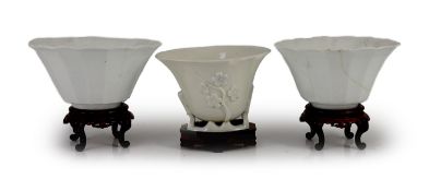 A pair of Chinese blanc-de-chine fluted bowls and a similar libation cup, Dehua kilns, 17th