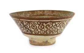 A Kashan inscribed copper lustre pottery bowl, Persia, 13th century,the interior with central