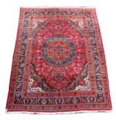 A Tabriz red ground carpetwith central lobed circular floral medallion, within a wide floral and