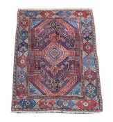 A Bergam Turkish blue ground rugwoven with a central hooked geometric medallion within a wide