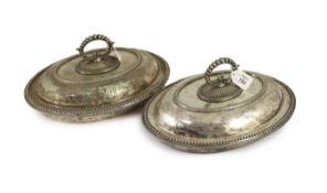 A pair of plated oval entree dishes, covers and detachable handles,with beaded borders, each