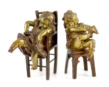 After Joan Clarà (1875 - 1958). A pair of bronze models of girls playing on chairs,signed in the