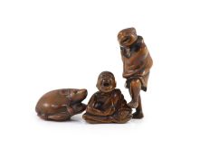 Three Japanese boxwood netsuke, 19th century,the first in the form of a rat eating a seedpod,