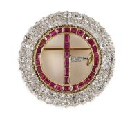 A 20th century gold and platinum, ruby and diamond set openwork circular 'buckle' brooch,with safety