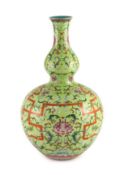 A Chinese lime green sgraffito ground double gourd vase, Qianlong mark but later,painted with lotus,