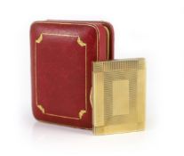 A 1930's Cartier 9ct gold compact, with diamond set thumbpiece,with reeded decoration and handled