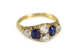 A Victorian style 18ct gold, four stone old round diamond and two stone sapphire set ring,with