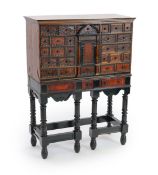 A 17th century Flemish style ebony and tortoiseshell cabinet on stand,with central cupboard