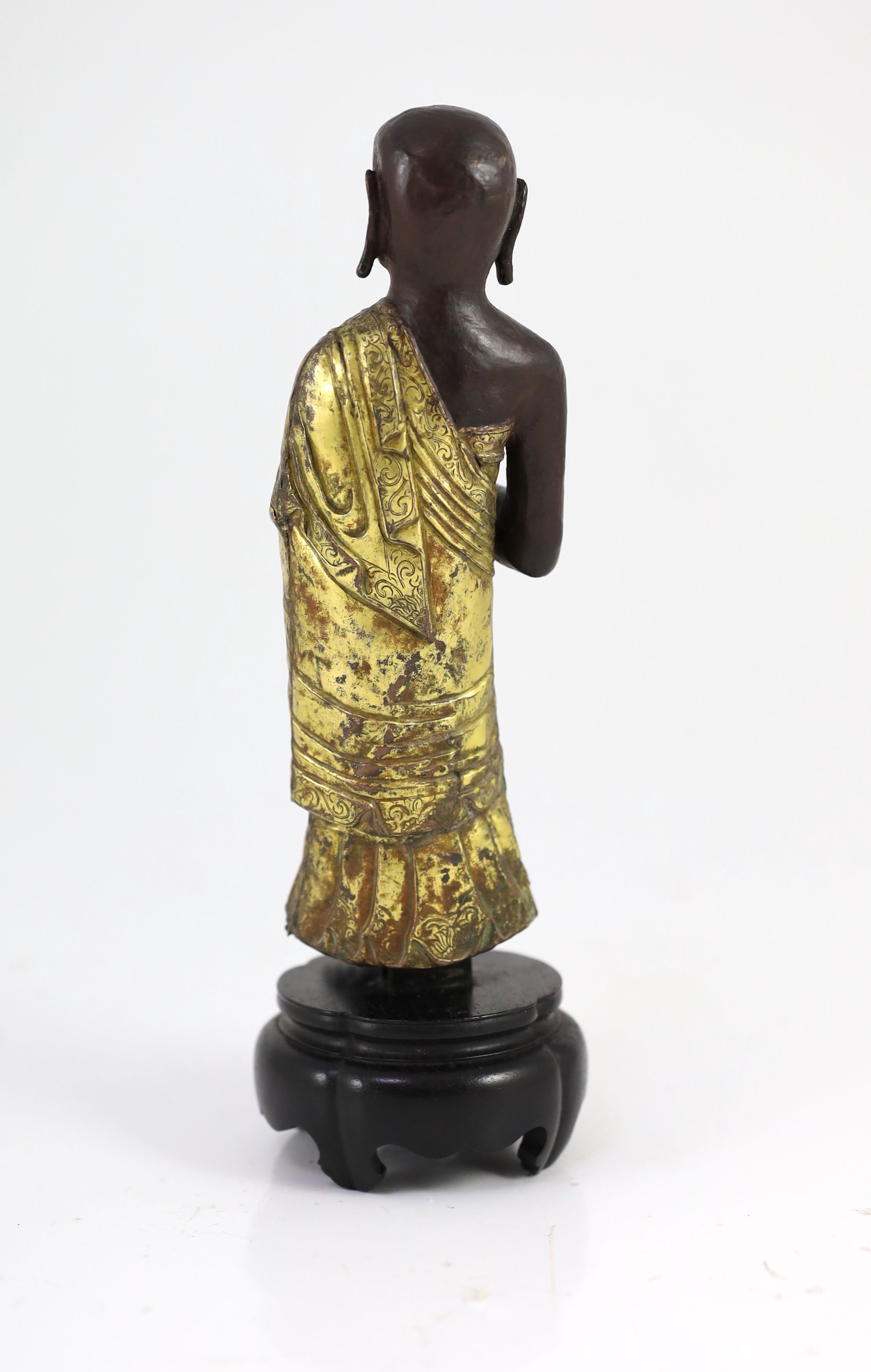 A Tibetan repousse work gilt and lacquered copper figure of a luohan, 18th century,standing and - Image 2 of 3