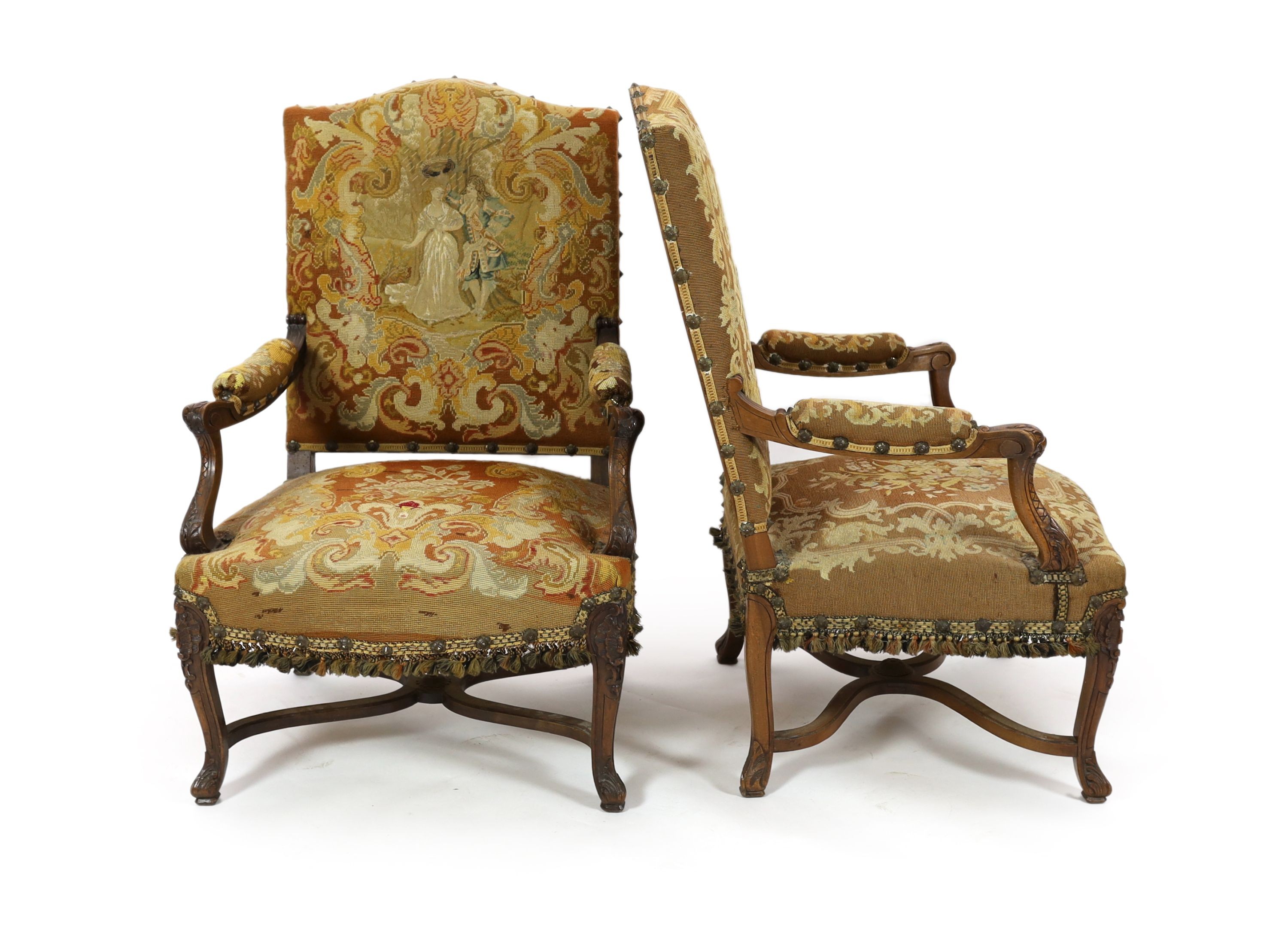 A pair of 19th century French walnut fauteuilswith scroll frames and part needlework upholsteryW.