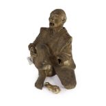 A Japanese terracotta figure of a kneeling and shouting man,formerly from Agatha Christie’s home,