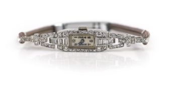 A lady's platinum, round and baguette cut diamond set rectangular manual wind cocktail watch,with on