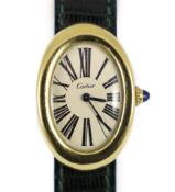 A lady's 18ct gold Cartier Baignoire manual wind oval wrist watch, on a Cartier green leather